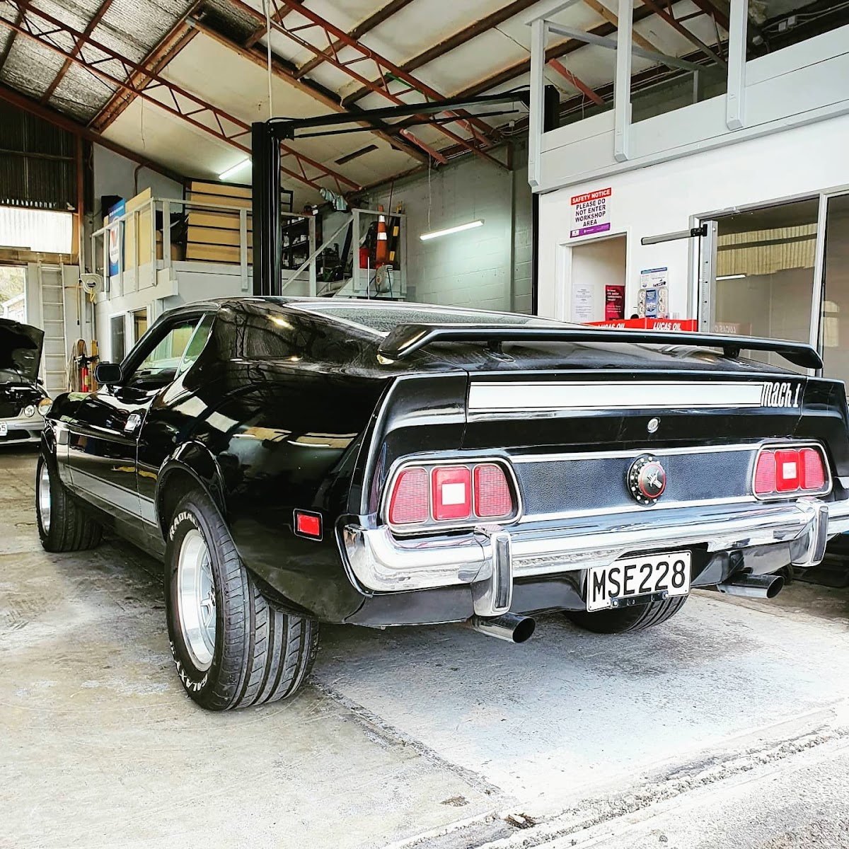 Black Mustang Mach 1 inside the workshop