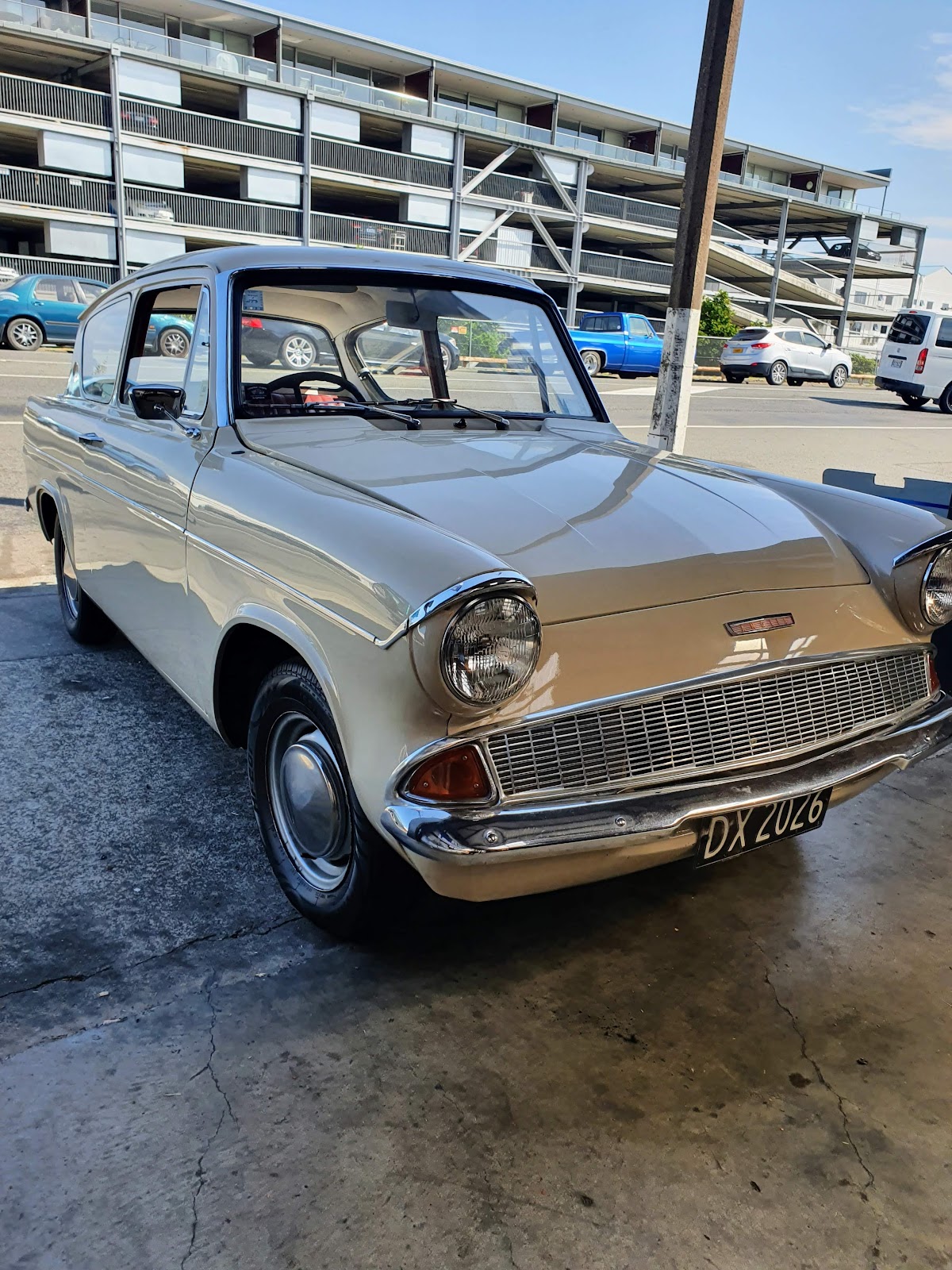 Cream Ford Anglia at the entrance of The Mechanic