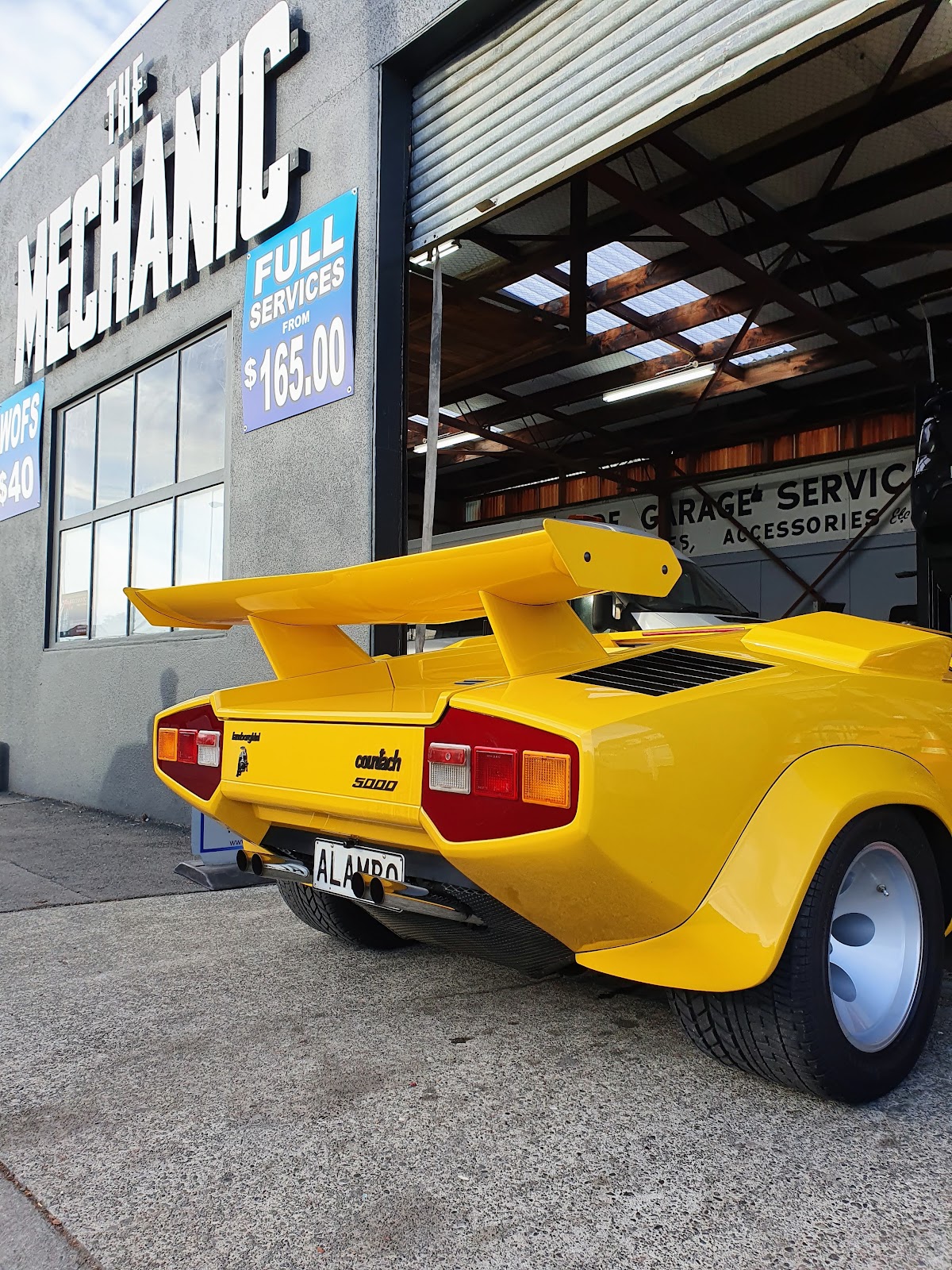 Yellow Lamborghini Countach outside The Mechanic workshop